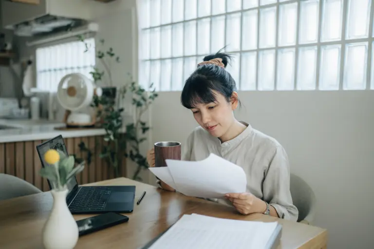 Woman reviewing personal loan documents at home office