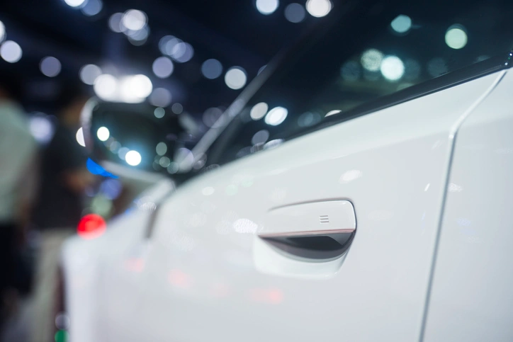 A close-up image of a white car door.