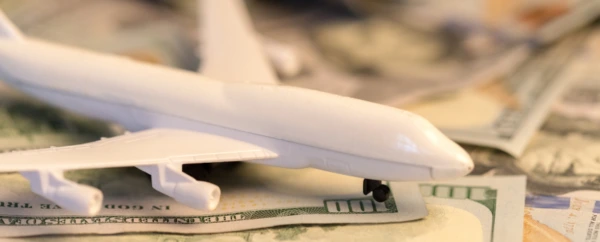 A model plane on top of cash.