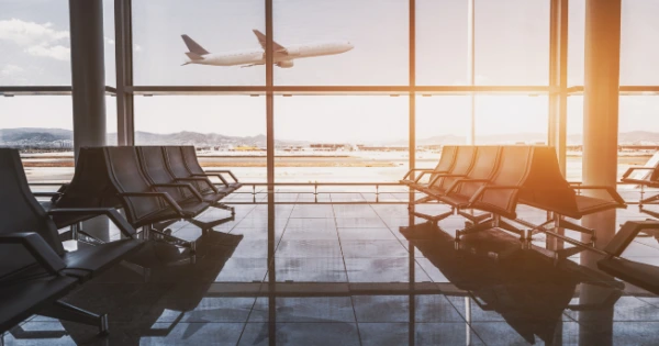An airplane taking off at sunrise.