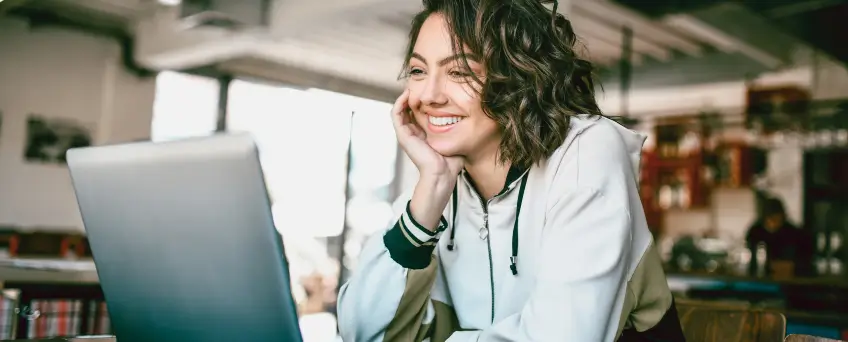 Woman smiling at laptop